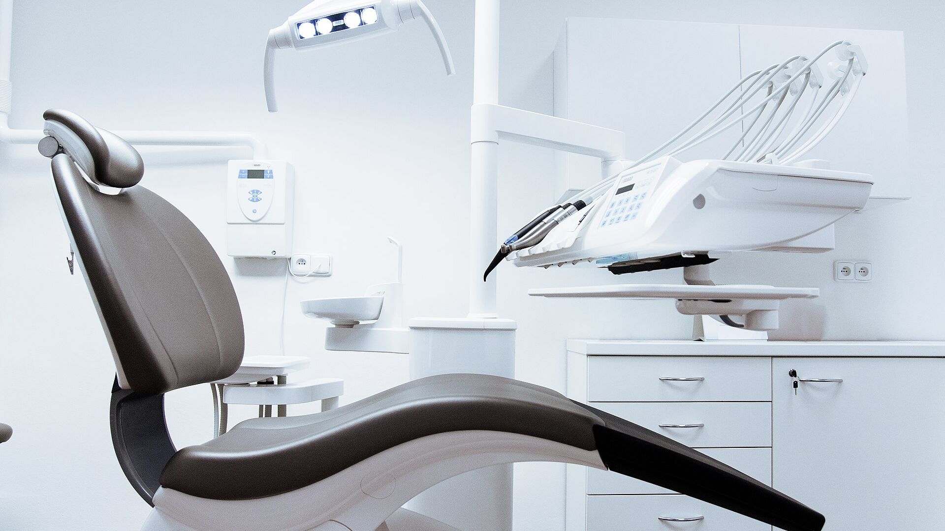 Dentist providing treatment to a patient in a modern dental operatory at Smile Care Dental Clinic, Zadeshwar, Bharuch